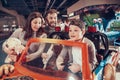 Happy family, enraptured son sitting on toy car Royalty Free Stock Photo