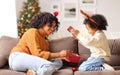 Ethnic mother and son opening Christmas presents together