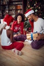 Happy  Family exchanging gifts in front of decorated Christmas tree Royalty Free Stock Photo