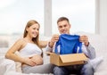 Happy family expecting child opening parcel box