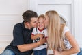 Happy Family Expecting New Baby. Pregnant Woman with Husband kiss the little son. Royalty Free Stock Photo