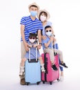 Happy family in face masks holding suitcases standing isolated on white background. People ready for summer vacation, safe travel Royalty Free Stock Photo