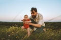 Happy family father and baby walking on grass outdoors Royalty Free Stock Photo