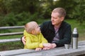 Happy Family: Father And Child Boy Son Playing And Laughing In Autumn Park, Sitting On Wooden Bench And Table. Father Royalty Free Stock Photo