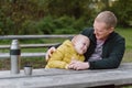 Happy Family: Father And Child Boy Son Playing And Laughing In Autumn Park, Sitting On Wooden Bench And Table. Father Royalty Free Stock Photo