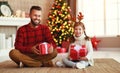 . happy family father and child daughter giving christmas gift Royalty Free Stock Photo