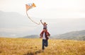 Happy family father and child daughter launch kite on meadow Royalty Free Stock Photo