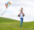 Happy family father and child daughter run with kite on meadow Royalty Free Stock Photo