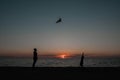 happy family father and child daughter run with kite in the meadow. silhouettes on the background of the sea sunset. Royalty Free Stock Photo