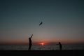 happy family father and child daughter run with kite in the meadow. silhouettes on the background of the sea sunset. Royalty Free Stock Photo