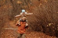 Happy family father and child daughter on a walk in the autumn leaf fall in park Royalty Free Stock Photo