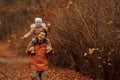 Happy family father and child daughter on a walk in the autumn leaf fall in park Royalty Free Stock Photo