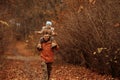 Happy family father and child daughter on a walk in the autumn leaf fall in park Royalty Free Stock Photo