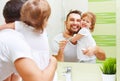 Happy family father and child girl brushing her teeth in bathroom toothbrushes Royalty Free Stock Photo