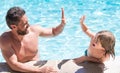 happy family of father and child having fun in summer swimming pool, summer Royalty Free Stock Photo