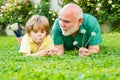 Happy family father and child on meadow with a kite in the summer on green grass. Cute boy with dad playing outdoor Royalty Free Stock Photo