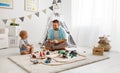 Happy family father and child son playing in toy railway in pl Royalty Free Stock Photo