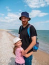 Happy family father daughter hugging on marine landscape. Bearded dad with child in hands having fun together Royalty Free Stock Photo