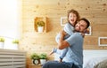 Happy family father and daughter reading book in bed Royalty Free Stock Photo