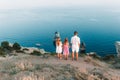 Happy family of four walking in the mountains on the sunset Royalty Free Stock Photo