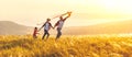 Happy family father, mother and child daughter launch a kite on Royalty Free Stock Photo