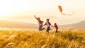 Happy family father, mother and child daughter launch a kite on Royalty Free Stock Photo