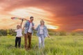 Happy family father, mother and child daughter launch a kite on nature at sunset Royalty Free Stock Photo