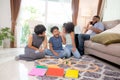 Happy family father and mother and children doing activity playing toy railway with fun in the living room. Royalty Free Stock Photo