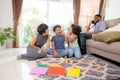 Happy family father and mother and children doing activity playing toy railway with fun in the living room. Royalty Free Stock Photo