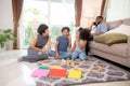 Happy family father and mother and children doing activity playing toy railway with fun in the living room. Royalty Free Stock Photo