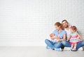 Happy family father mother and children at empty wall Royalty Free Stock Photo