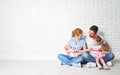 Happy family father mother and children at empty wall Royalty Free Stock Photo