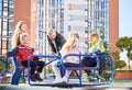 Happy family - father, mother and children having fun together on playground. Royalty Free Stock Photo