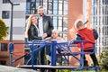 Happy family - father, mother and children having fun together on playground. Royalty Free Stock Photo