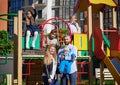 Happy family - father, mother and children having fun together on playground. Royalty Free Stock Photo