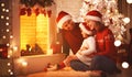 Happy family sitting by fireplace on Christmas Eve Royalty Free Stock Photo