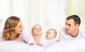 Happy family of father, mother and children in white bed Royalty Free Stock Photo