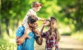 Happy family, father, mother and daughter are playing in the park and enjoying a sunny summer day Royalty Free Stock Photo