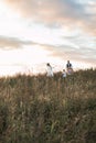 Happy family, father, mother and female children, having fun, running and enjoying life together at wild field in Royalty Free Stock Photo