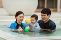 happy family. father and mother with small daughter in swimming pool Royalty Free Stock Photo