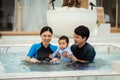 happy family. father and mother with small daughter in swimming pool Royalty Free Stock Photo