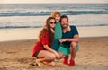 Happy family father, mother and son child hold hands and walk along sea surf on sand beach. Active parents and people Royalty Free Stock Photo