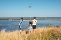 A happy family. Father, son and daughter fly a kite in the field. Back view Royalty Free Stock Photo