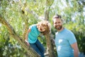 Happy family. Father and son smile sitting on tree. Family fun. Childhood and parenthood