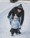 Happy family father and son walking in winter park Royalty Free Stock Photo