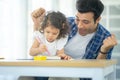 Happy family: Father teaching his cute little daughters` study. Family creativity and education at child`s room, home schooling Royalty Free Stock Photo