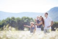 Happy family on a field of blooming daisies Royalty Free Stock Photo