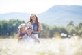 Happy family on a field of blooming daisies Royalty Free Stock Photo