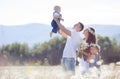 Happy family on a field of blooming daisies Royalty Free Stock Photo