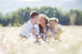 Happy family on a field of blooming daisies Royalty Free Stock Photo